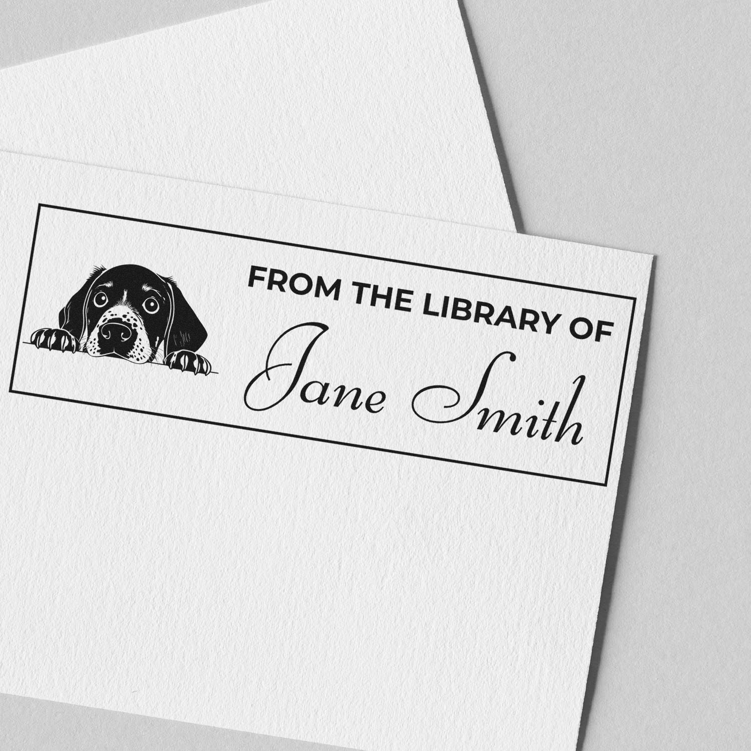 Personalized dog rubber stamp reading From the Library of Jane Smith for custom bookplates and library books.