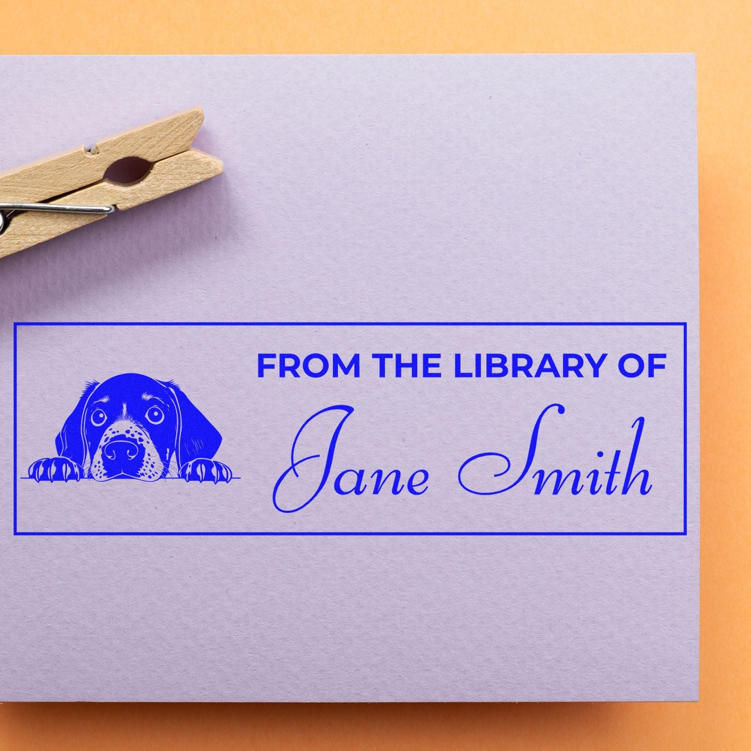 Personalized rubber library stamp with dog design and From the Library of Jane Smith text for books and bookplates.