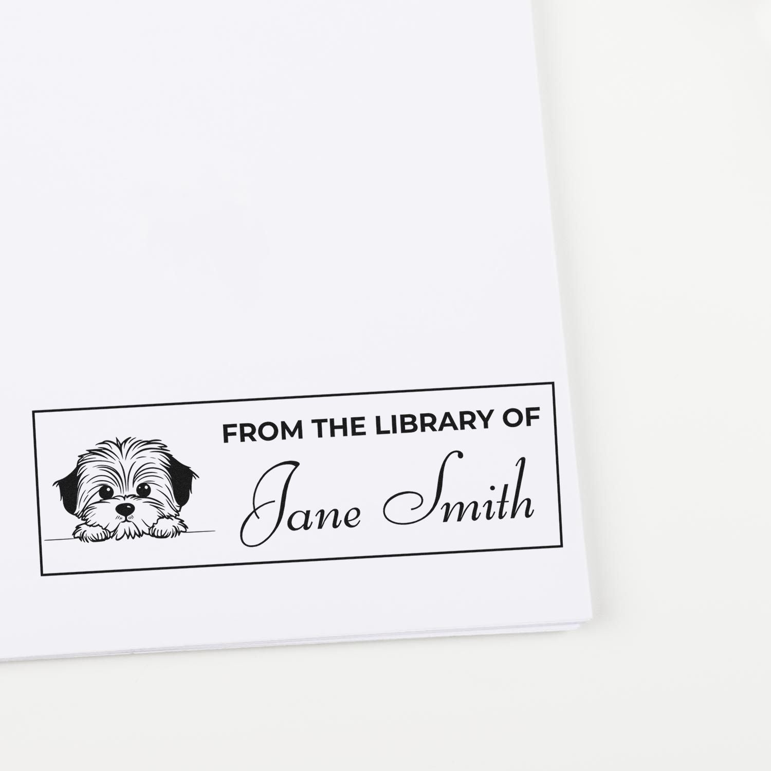 Custom From the Library Of rubber stamp with dog illustration and personalized name Jane Smith for book ownership labeling.