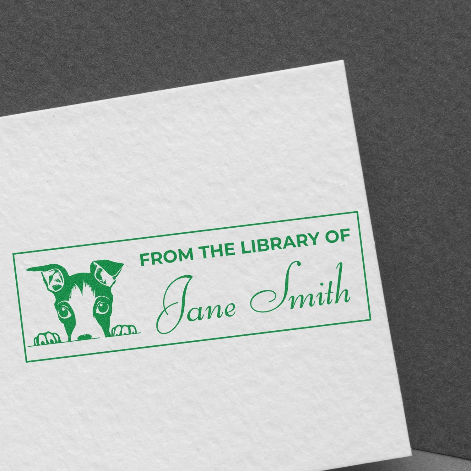 Custom personalized rubber stamp reading From the Library of Jane Smith with dog illustration for books and library returns.