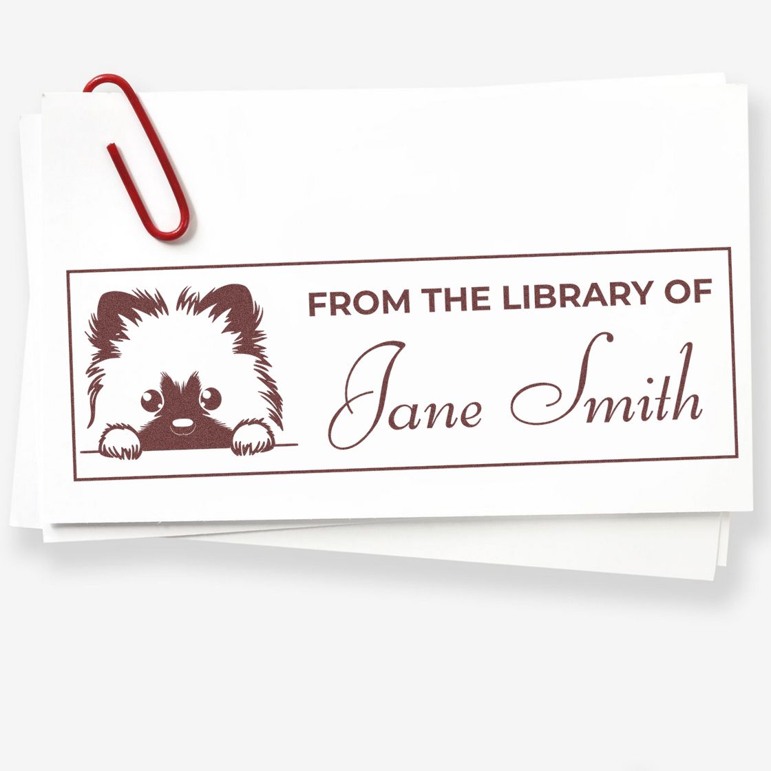 Personalized bookplate rubber stamp reading From the Library of Jane Smith with dog illustration for custom books.