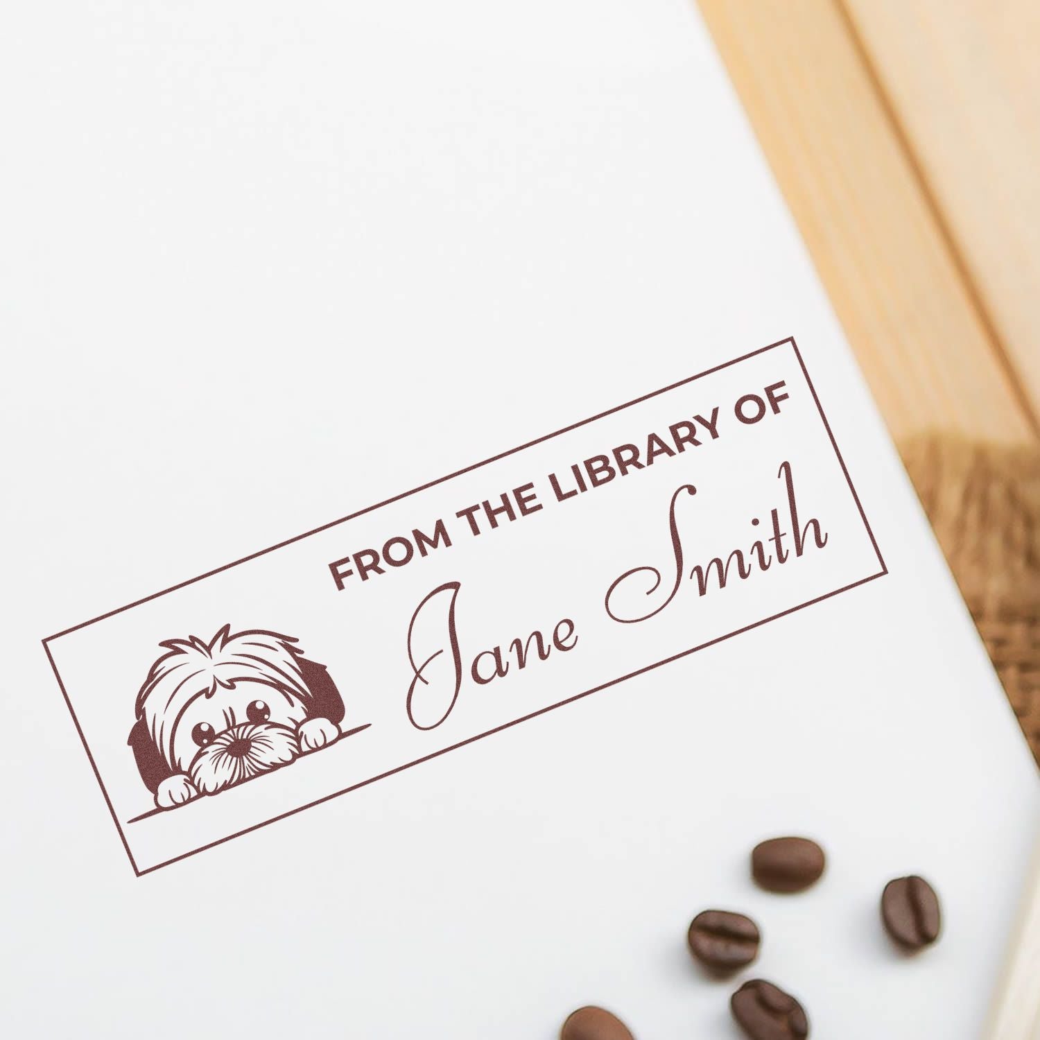 Custom rubber book stamp with dog design, marking a book as From the Library of Jane Smith personalized ownership imprint.