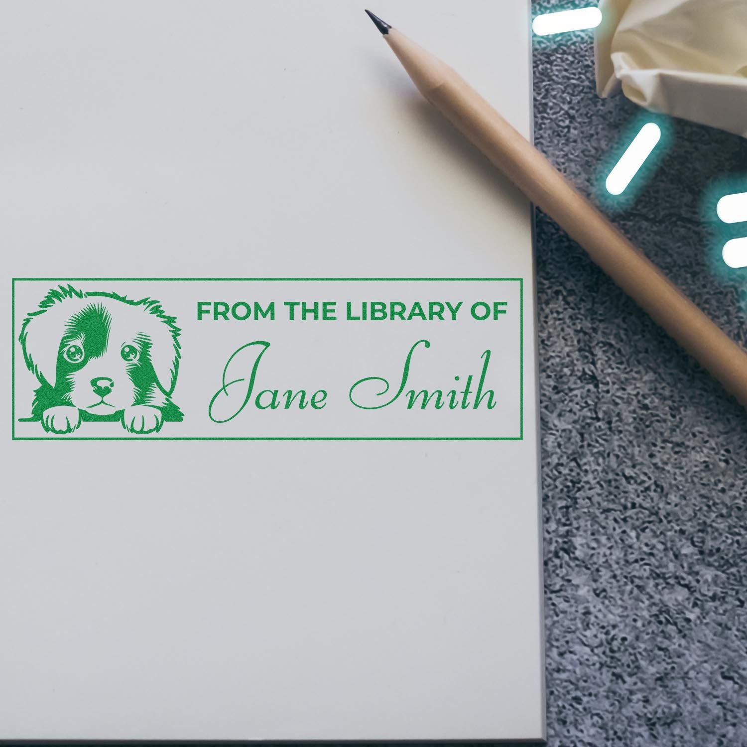 Custom library rubber stamp with puppy graphic and From the Library of Jane Smith for personalized bookplates.