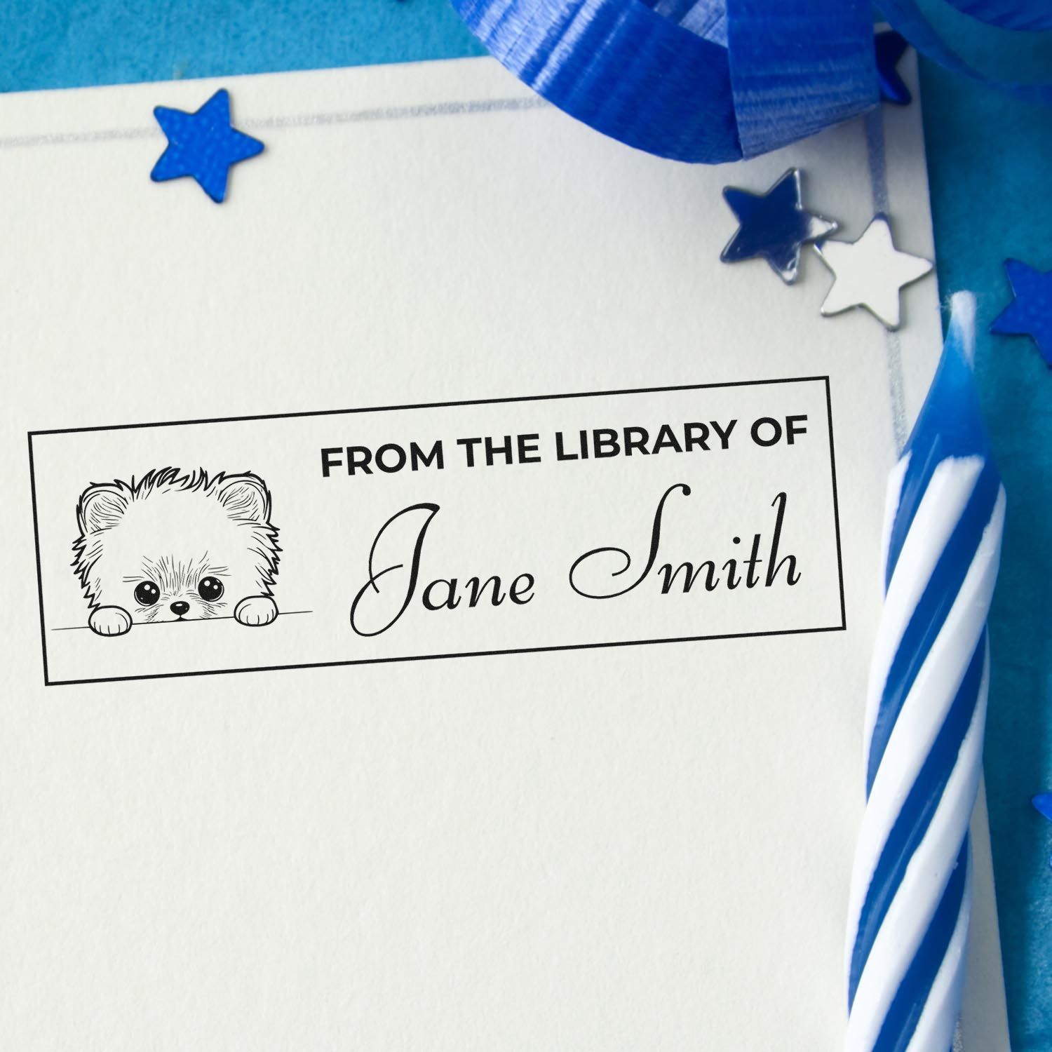 Personalized rubber library stamp with bear design and name Jane Smith for book ownership, with blue stars and ribbon.