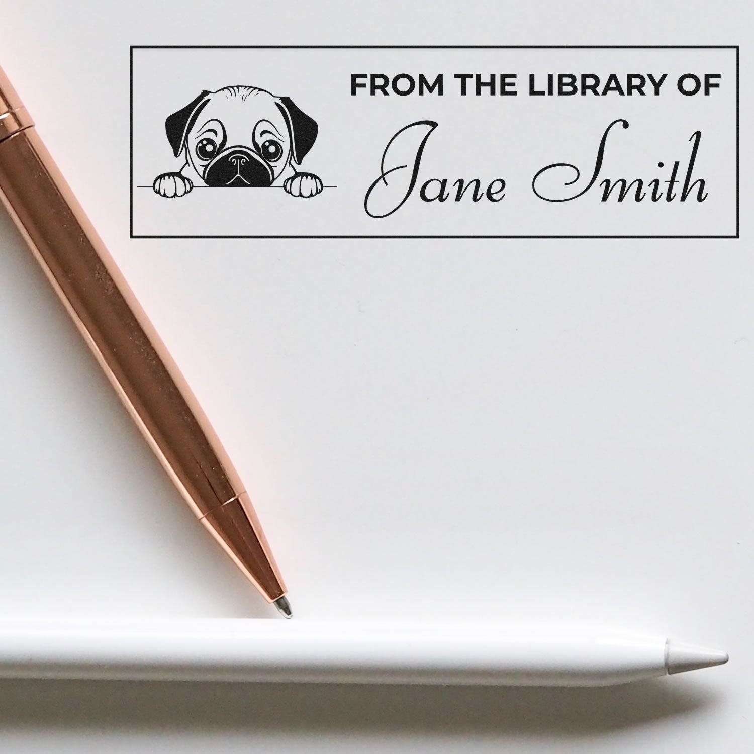 Personalized library rubber stamp with dog design and From the Library of Jane Smith book ownership text.