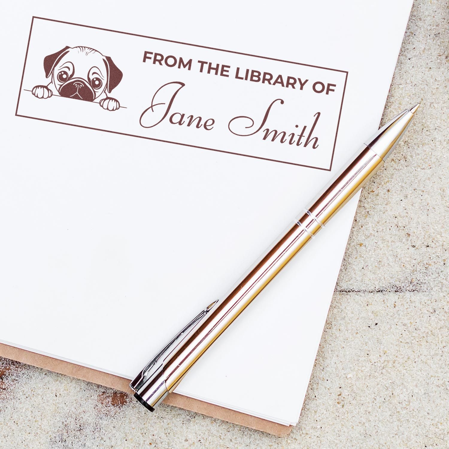Personalized library rubber stamp with pug illustration and From the Library of Jane Smith bookplate text.