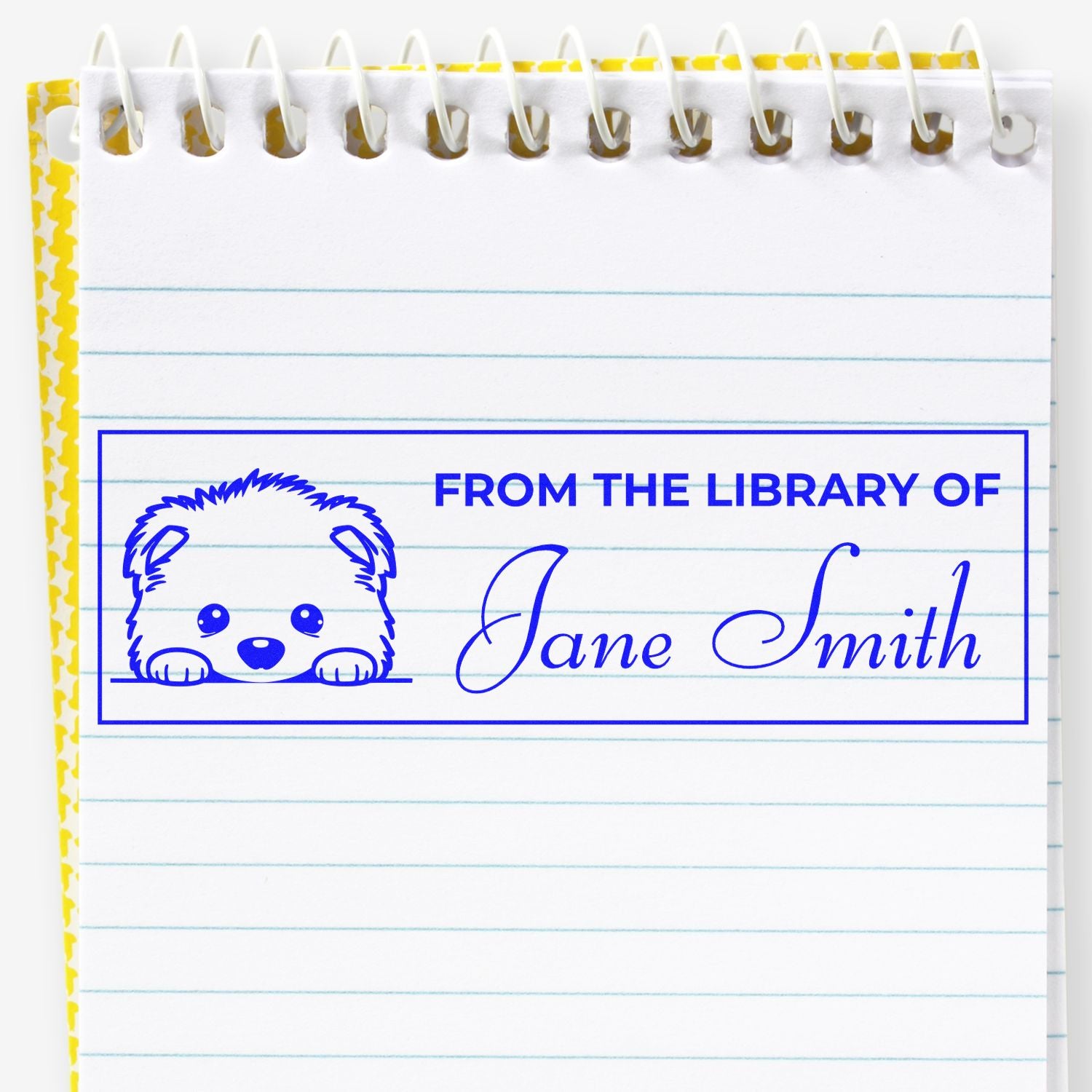 Custom library rubber stamp with dog design and From the Library of Jane Smith bookplate on lined notebook paper.
