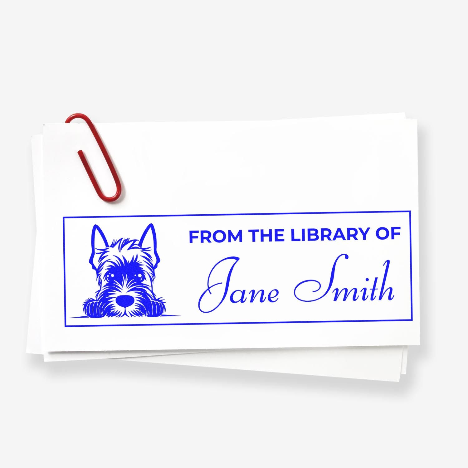 Custom personalized library rubber stamp with dog design, reading From the Library of Jane Smith for book labeling.