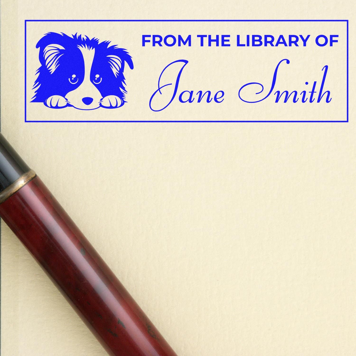 Personalized library rubber stamp with dog illustration and From the Library of Jane Smith for book labeling.