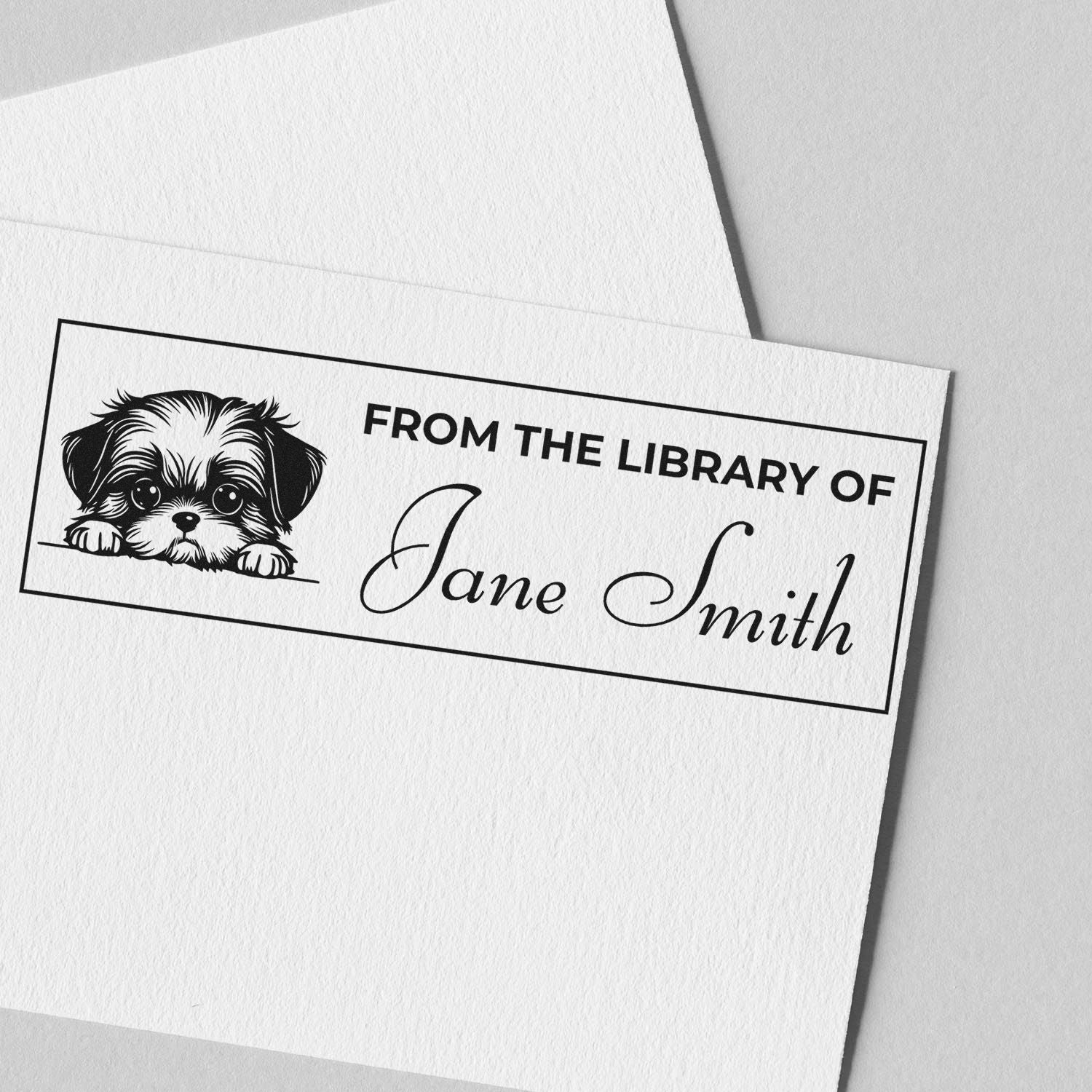 Personalized library bookplate rubber stamp with dog illustration, reading From the Library of Jane Smith.