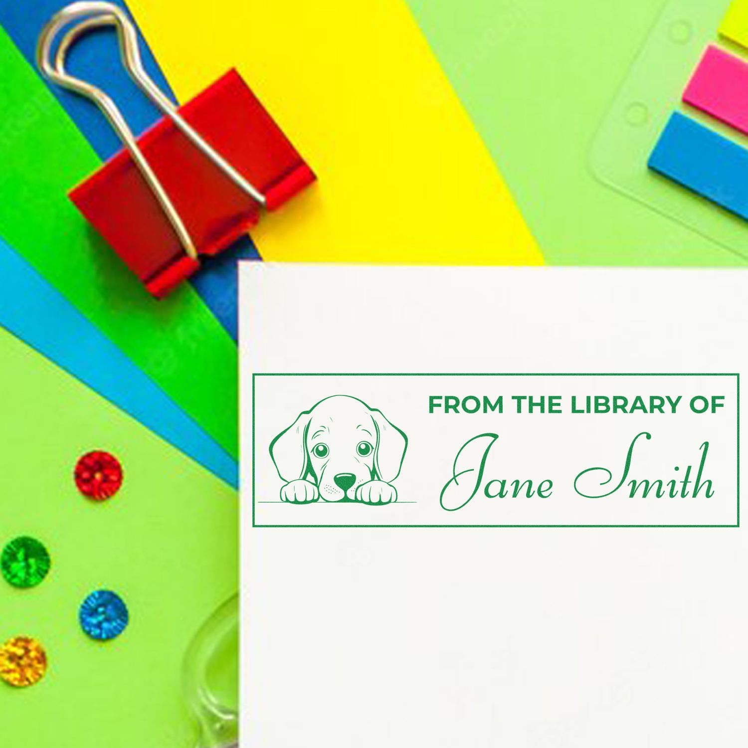 Personalized library rubber stamp with dog illustration, reading From the Library of Jane Smith for custom book labeling.