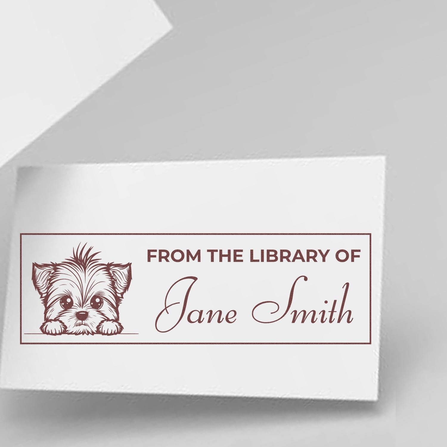 Personalized rubber library stamp with puppy illustration and From the Library of Jane Smith custom book stamp text.
