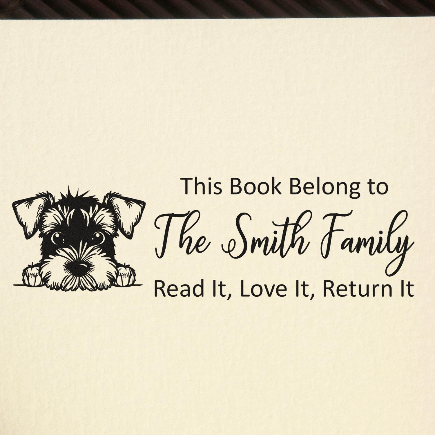 Personalized book return rubber stamp with dog illustration, family name, and Read It, Love It, Return It message.