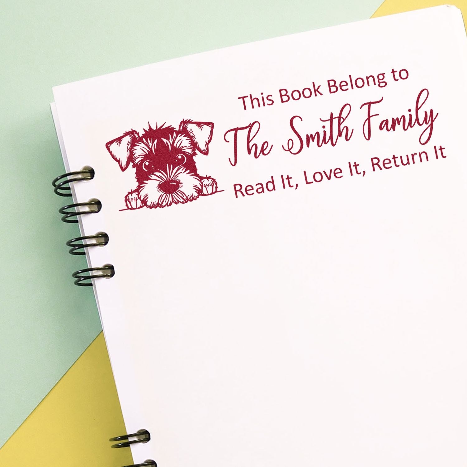 Custom rubber book stamp with dog illustration and This Book Belongs to The Smith Family personalized return book stamp.