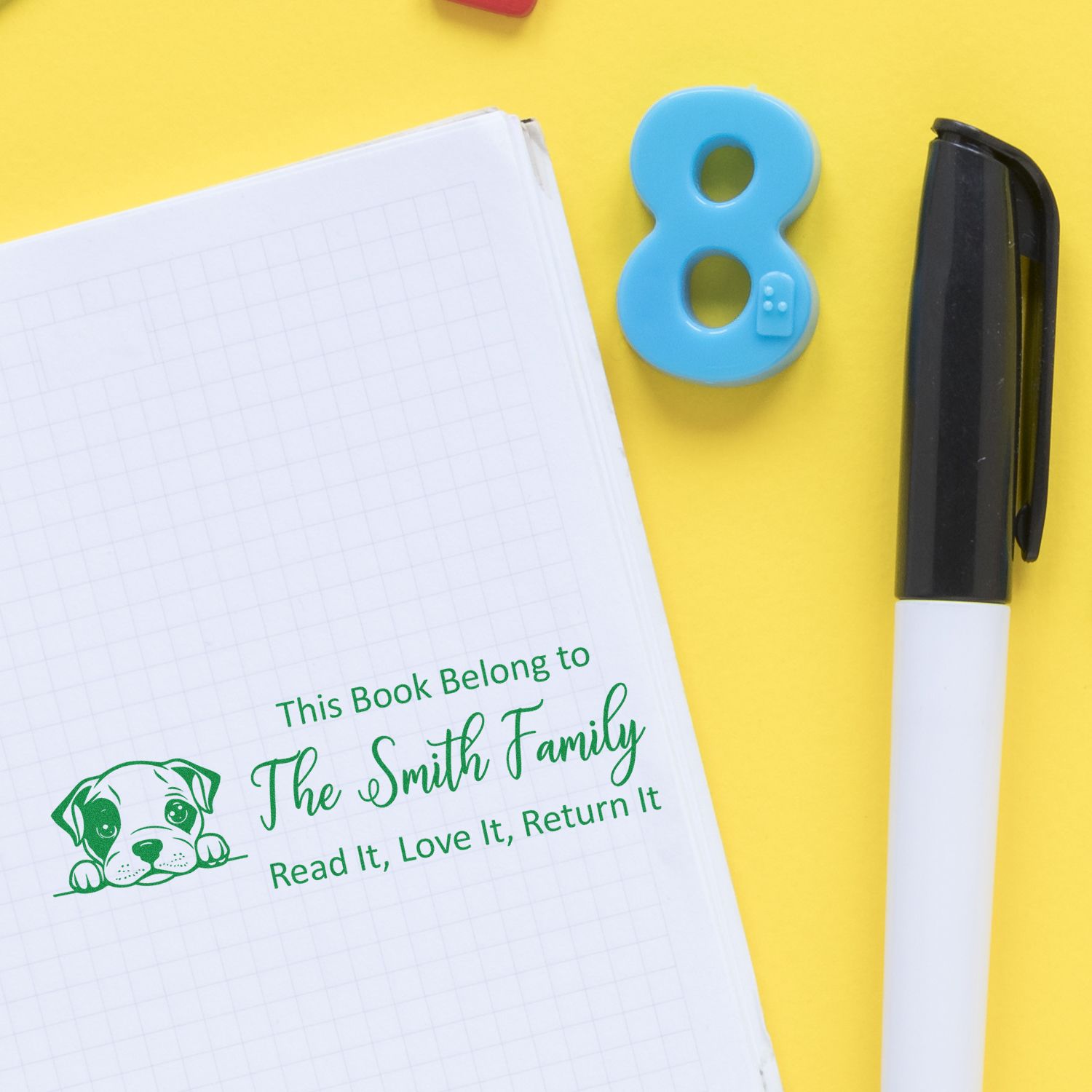 Custom rubber book stamp personalized for The Smith Family, with dog icon, marking books "Read It, Love It, Return It."