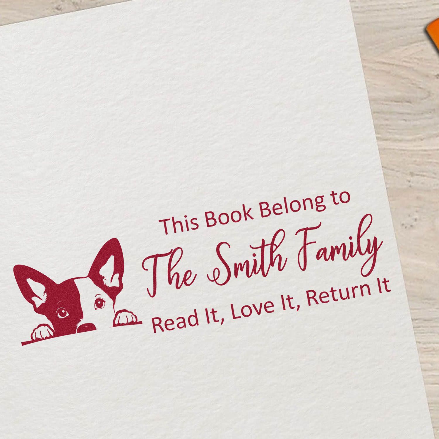 Custom rubber book stamp with dog design and family name, reading This Book Belong to The Smith Family, Read It, Love It, Return It.