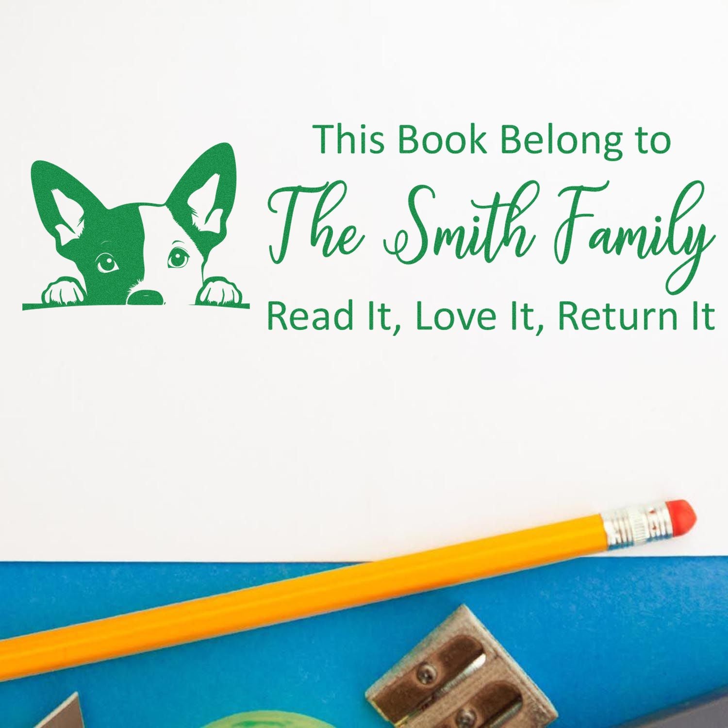Personalized rubber book stamp for The Smith Family with dog design and Read It, Love It, Return It library ownership text.