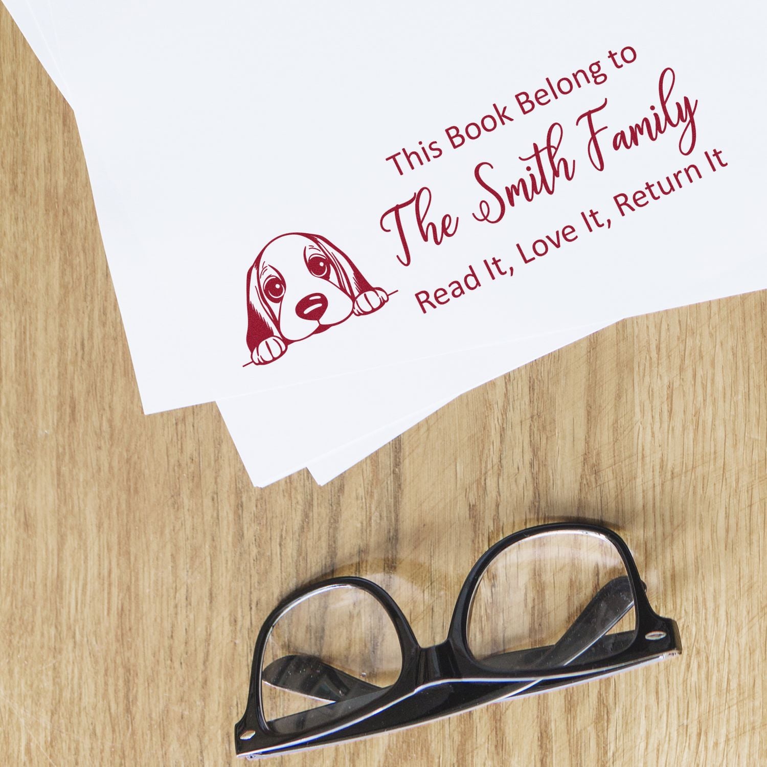 Custom rubber book stamp with dog illustration and Read It, Love It, Return It message for The Smith Family.