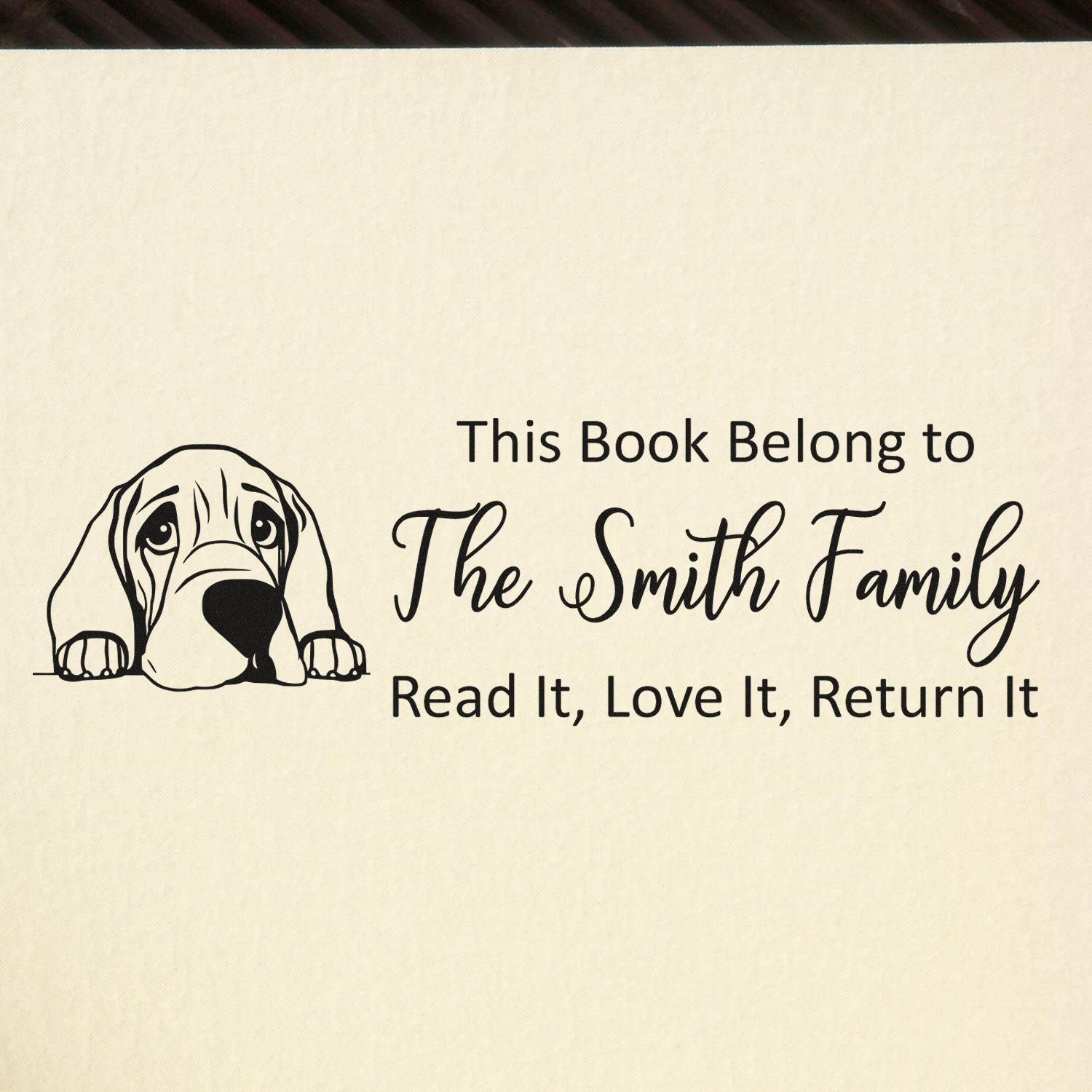 Personalized rubber stamp bookplate with dog illustration and This Book Belongs to The Smith Family, Read It, Love It, Return It text.