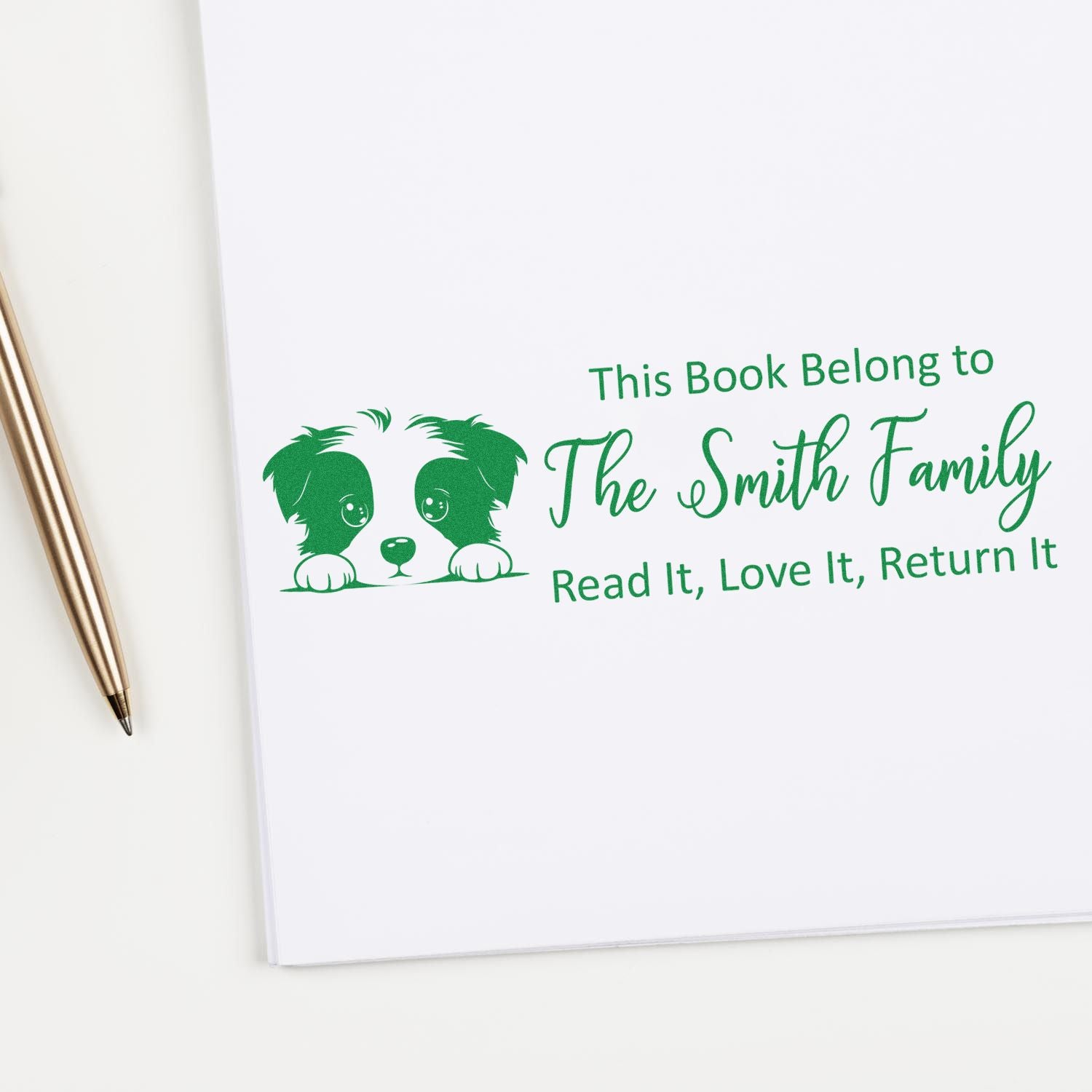 Personalized rubber stamp for books with dog graphic and family name, reading This Book Belongs to The Smith Family return message.
