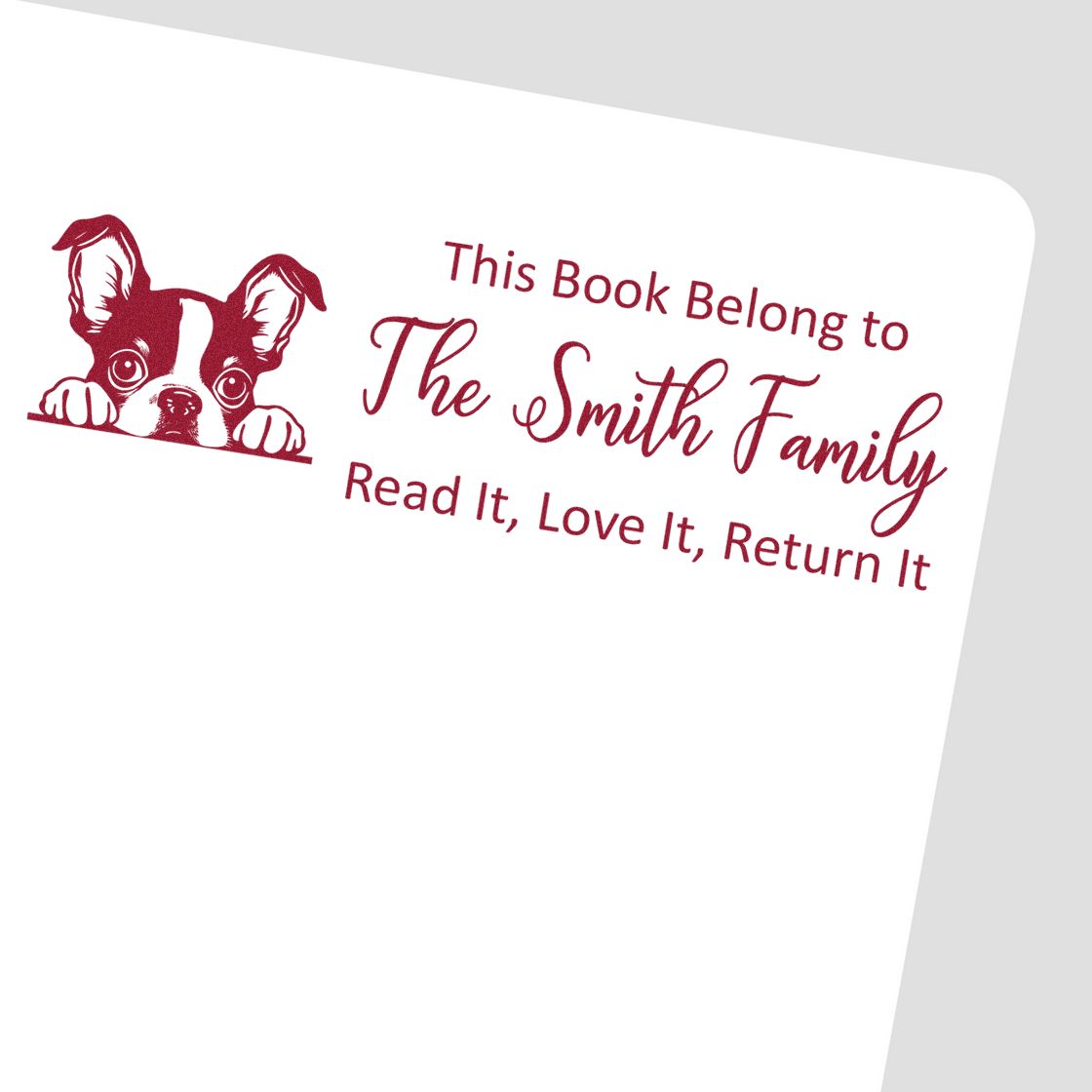 Custom rubber book stamp with dog illustration and This Book Belongs to The Smith Family, Read It, Love It, Return It text.