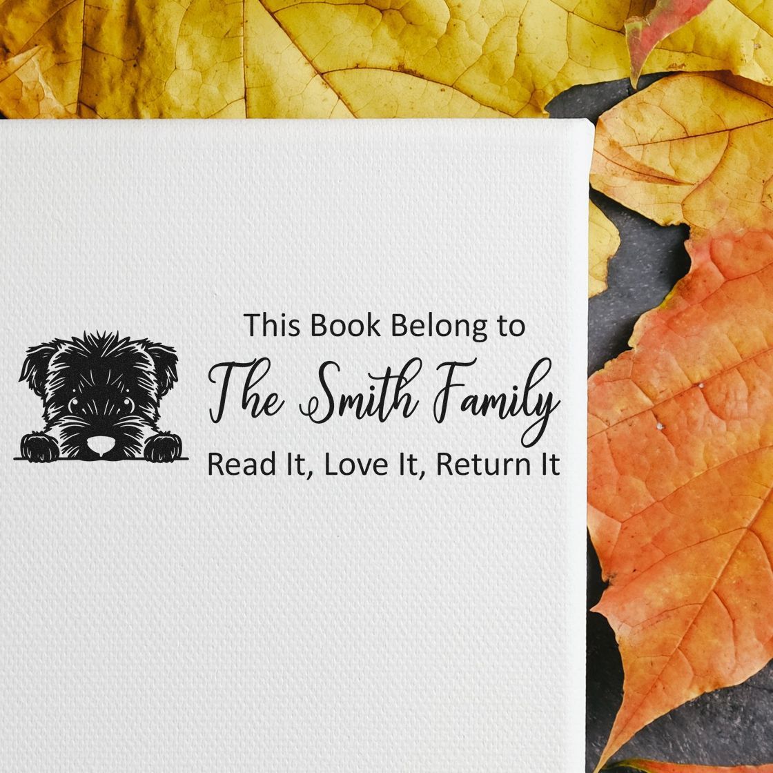 Custom library rubber stamp with dog graphic and This Book Belong to The Smith FamilyRead It, Love It, Return It text.