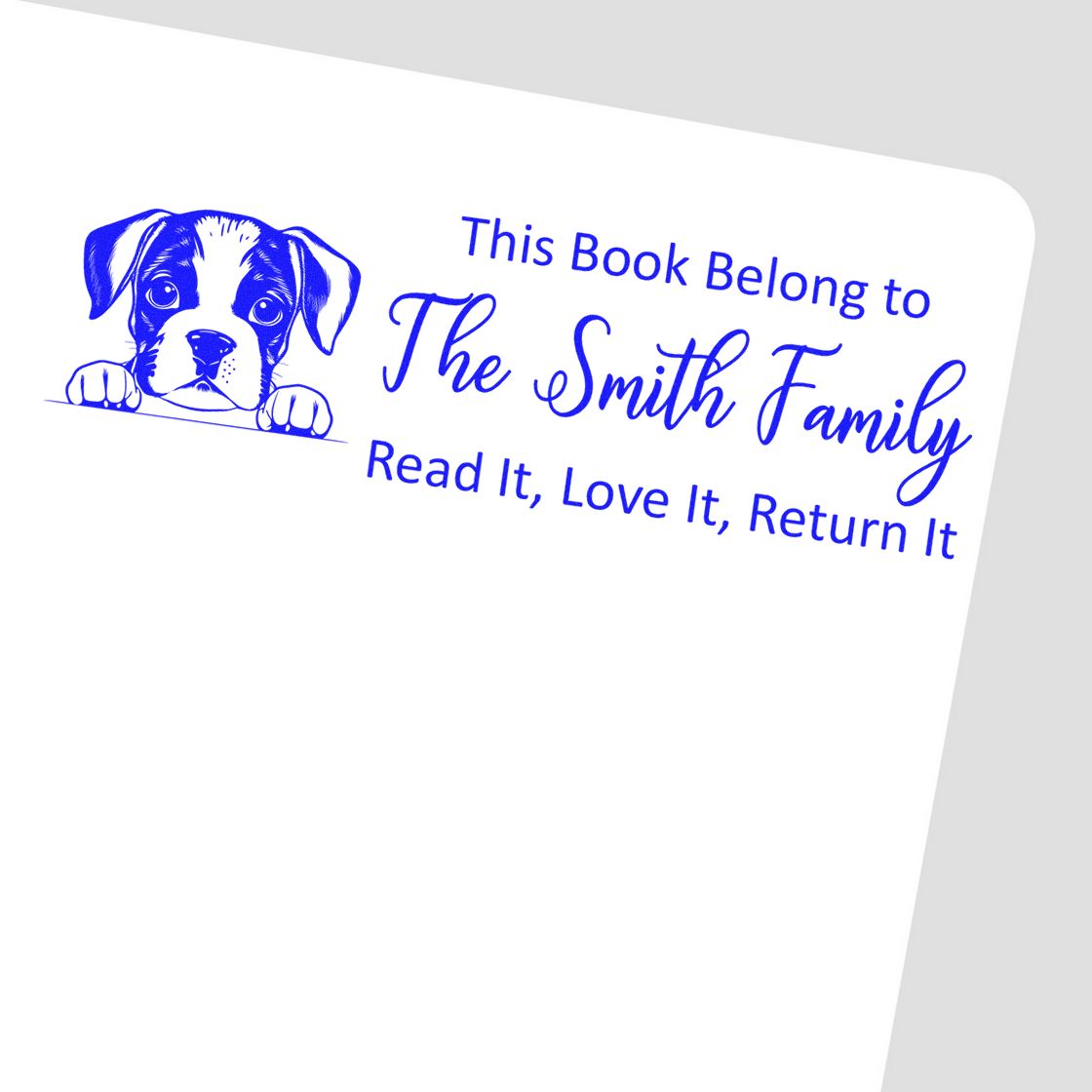 Custom rubber stamp with puppy illustration and This Book Belong to The Smith Family return message for personalized books.