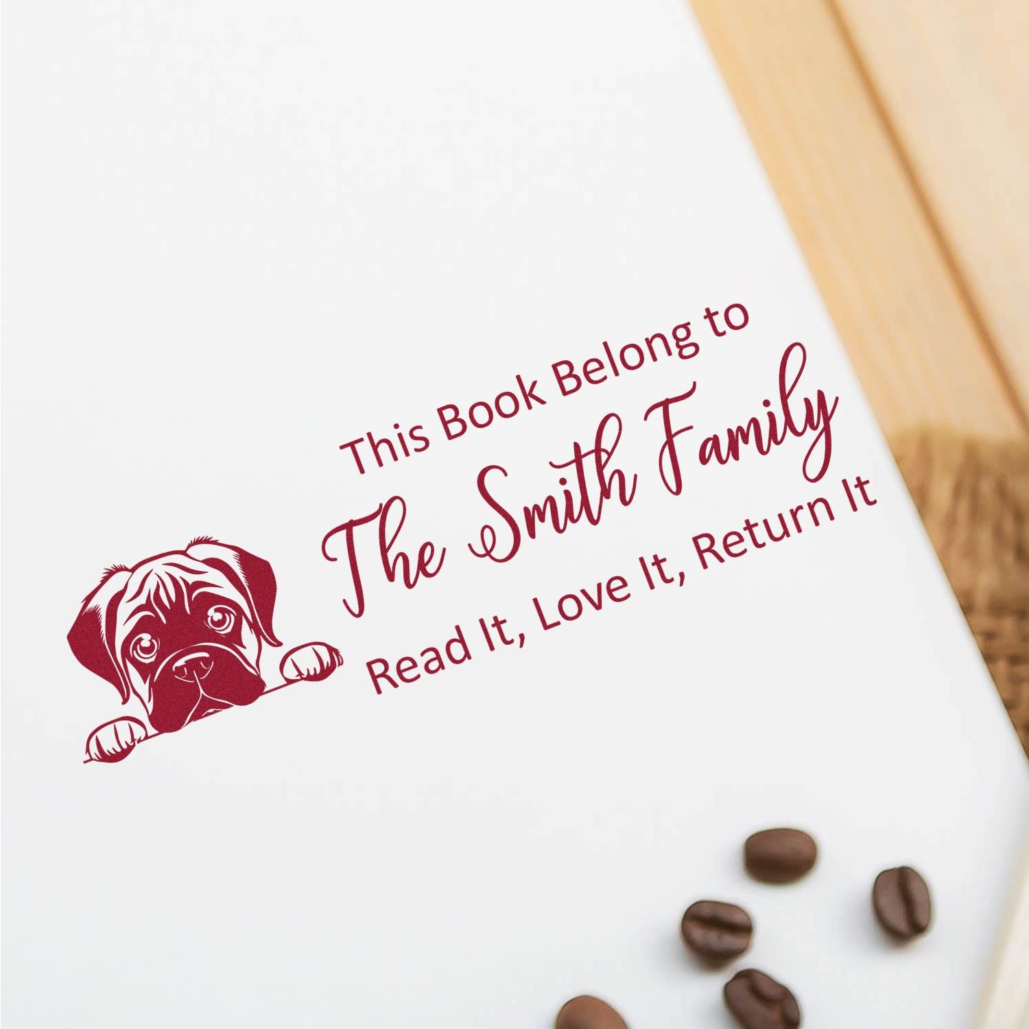 Custom rubber stamp with dog design and This Book Belongs to The Smith Family book return message for library books.