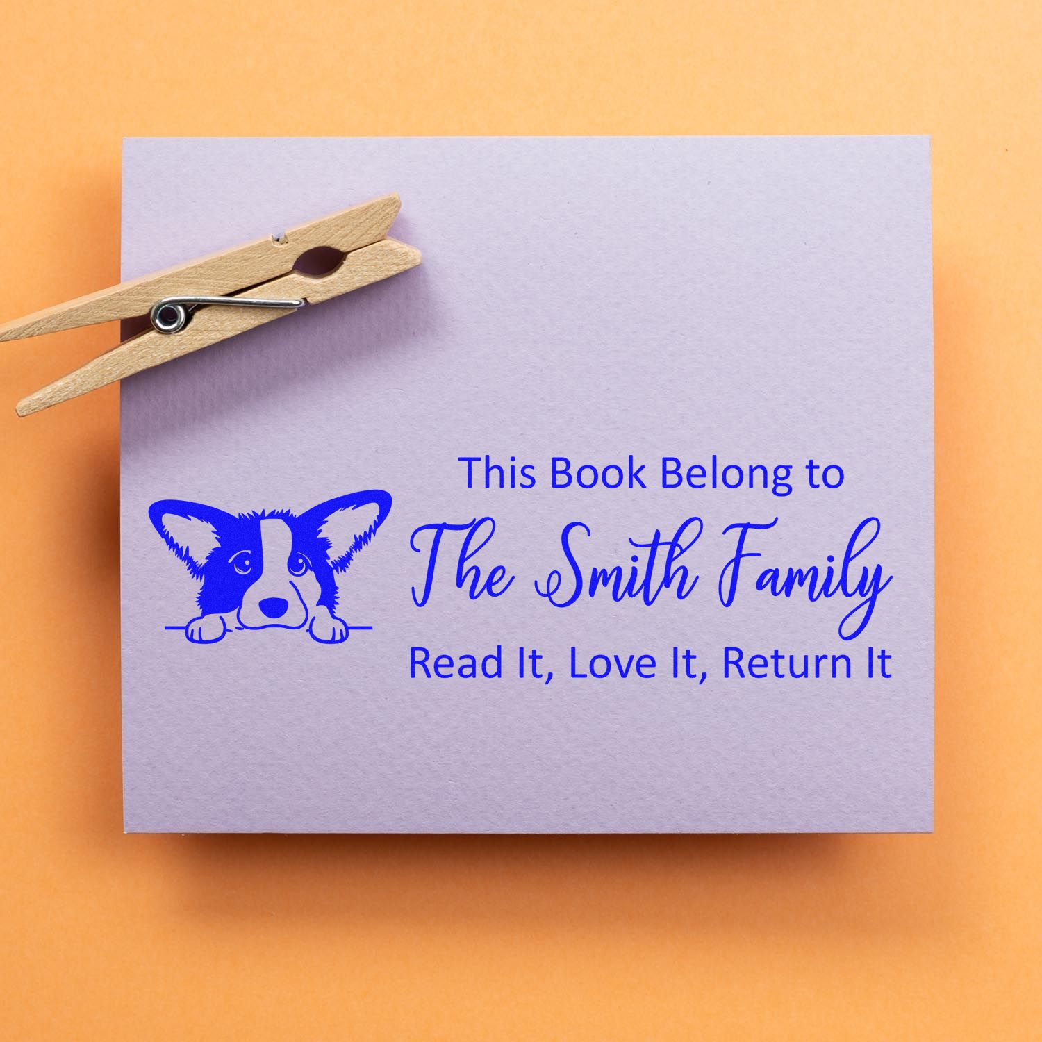Personalized bookplate rubber stamp with dog design and This Book Belong to The Smith Family return-it message.