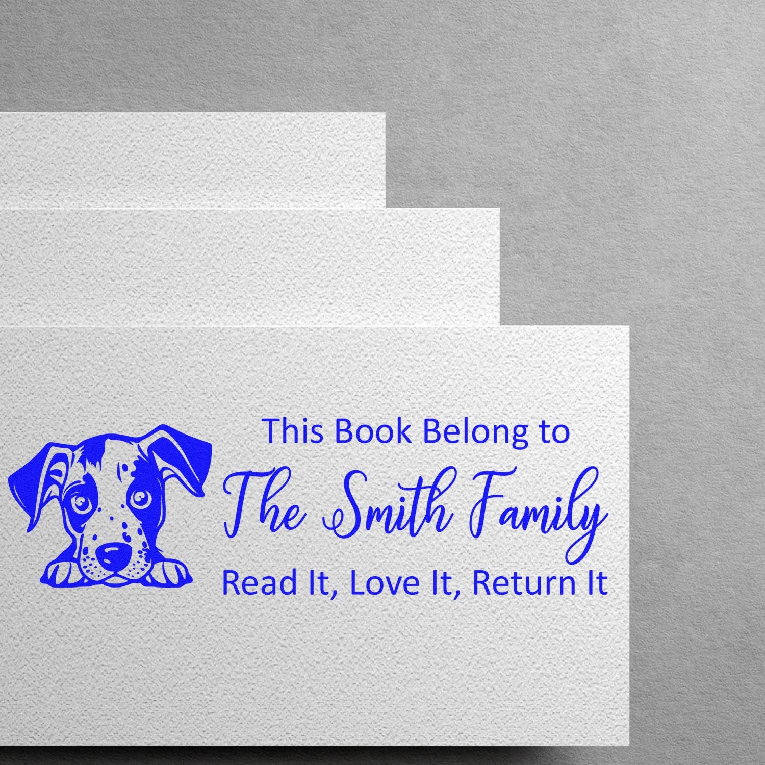 Personalized rubber book stamp with dog illustration: This Book Belongs to The Smith Family, Read It, Love It, Return It.