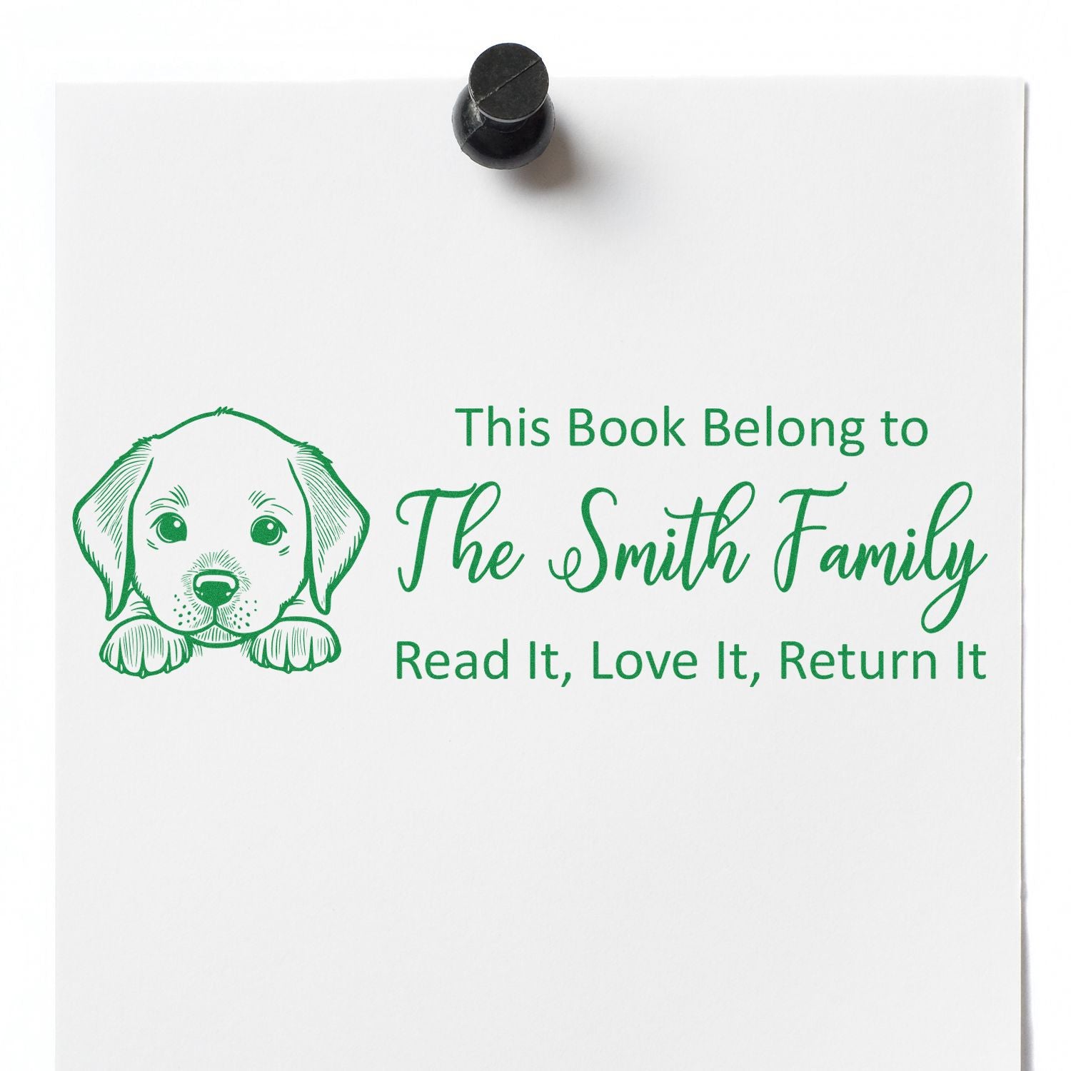 Personalized rubber book stamp with puppy design and This Book Belongs to The Smith Family return message.