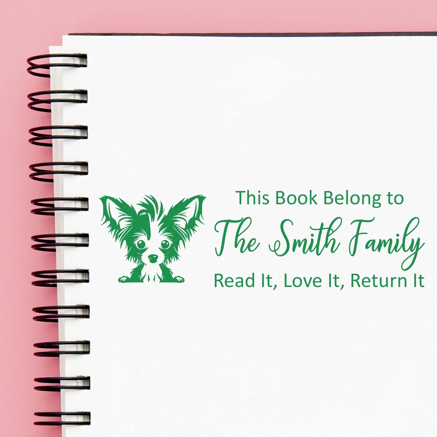 Custom rubber book stamp with dog design for The Smith Family, marking library books: Read it, love it, return it.