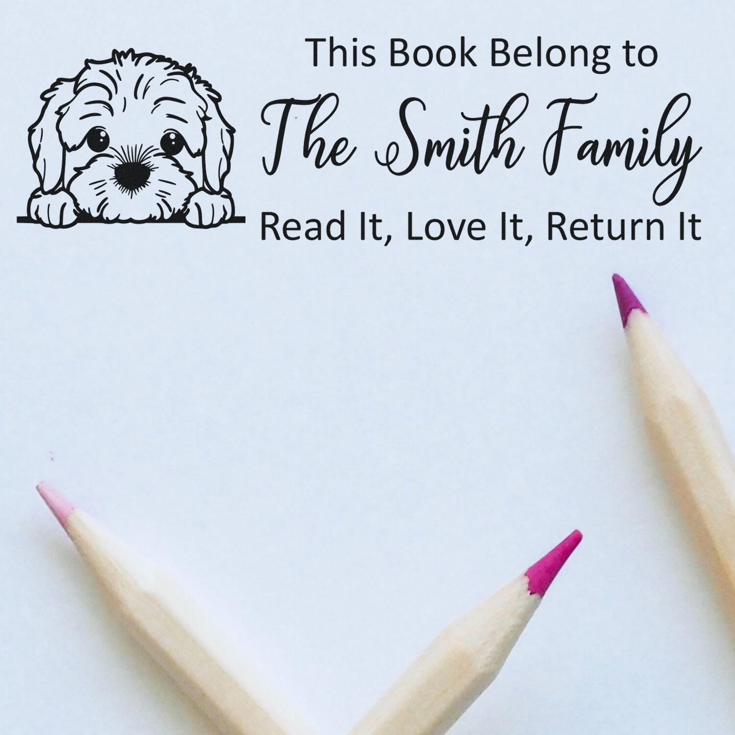 Custom library rubber stamp with dog illustration: This Book Belongs to The Smith Family, Read It, Love It, Return It.