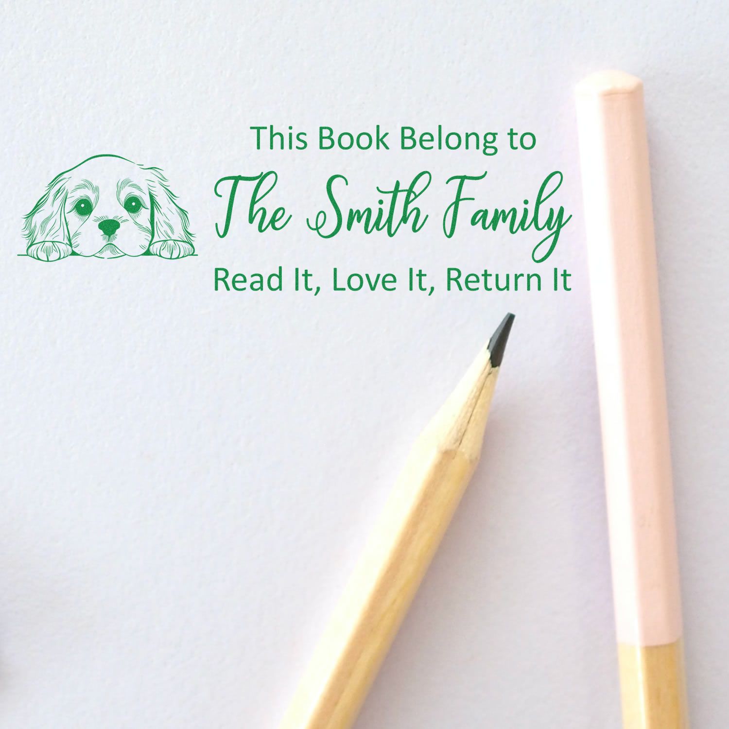 Personalized book rubber stamp for The Smith Family with dog illustration and Read It, Love It, Return It message.