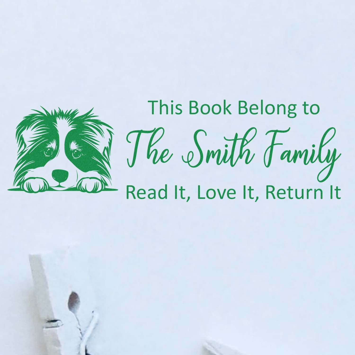 Custom book rubber stamp with dog art and This Book Belong to The Smith Family return message.