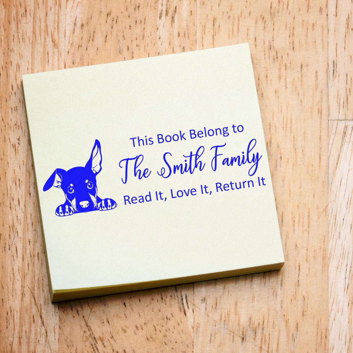 Personalized dog bookplate rubber stamp for family libraries, reading This Book Belongs to The Smith Family with a return-it message.