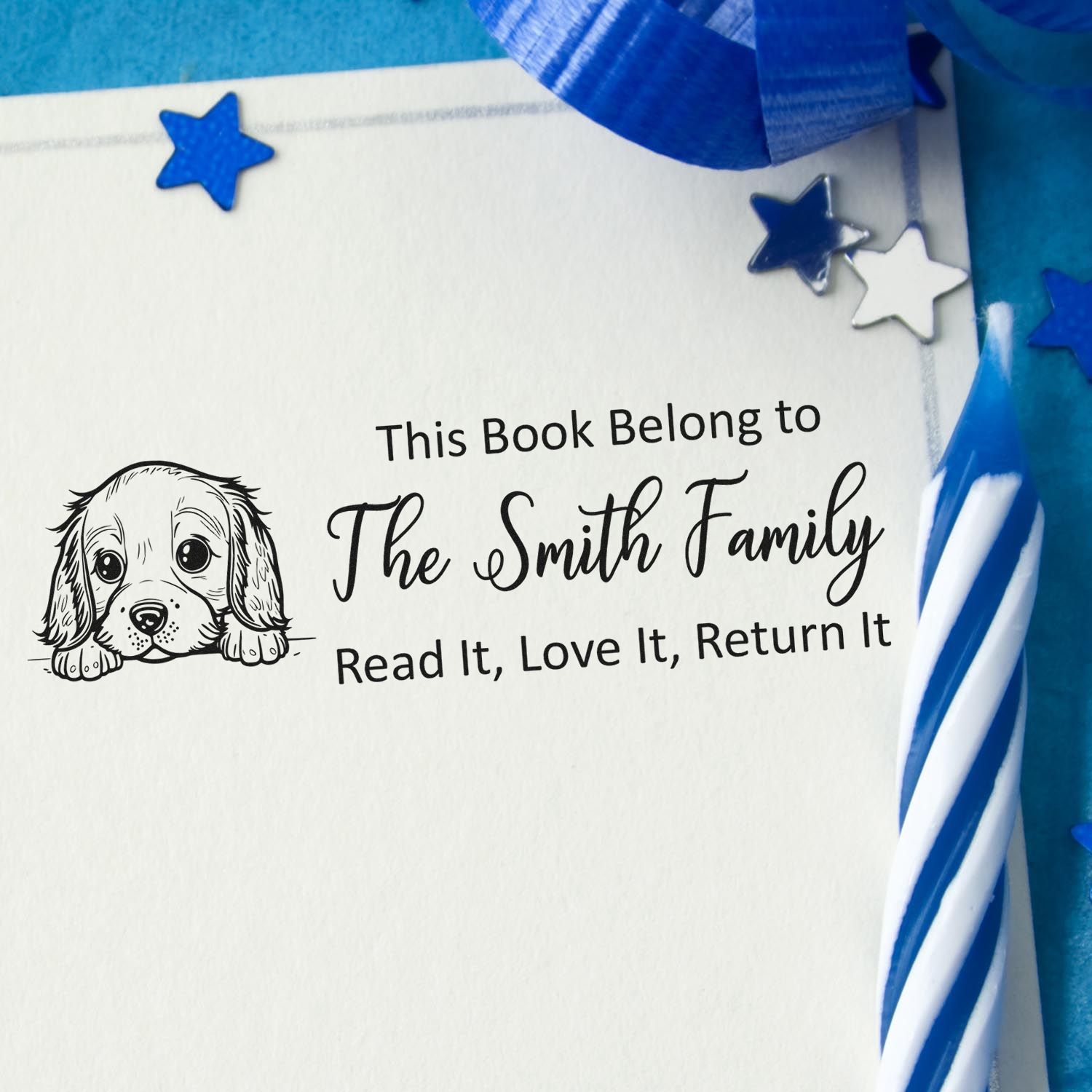 Custom rubber book stamp with puppy illustration and This Book Belongs to The Smith Family read-and-return message.