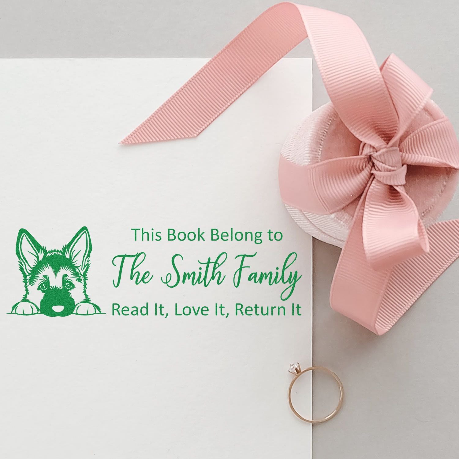 Personalized rubber book stamp with dog logo and This Book Belong to The Smith Family for library books and return reminders