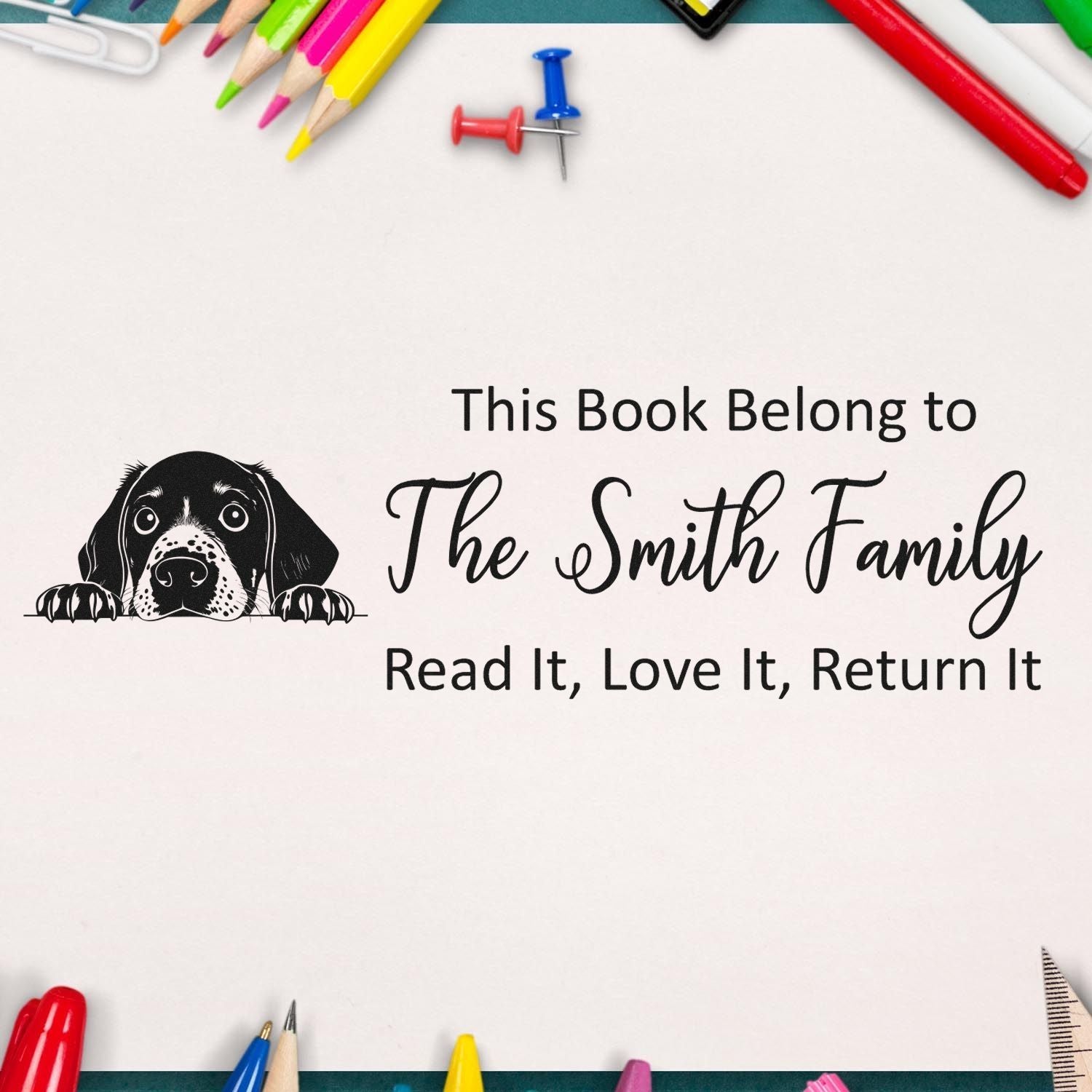 Personalized rubber stamp for books with dog illustration and This Book Belongs to The Smith Family return message.