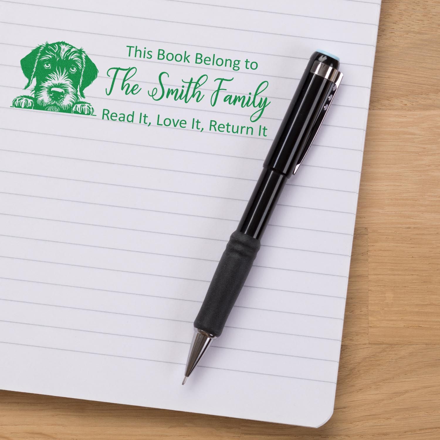 Custom rubber book stamp with puppy design, personalizing library books with This Book Belong to The Smith Family.