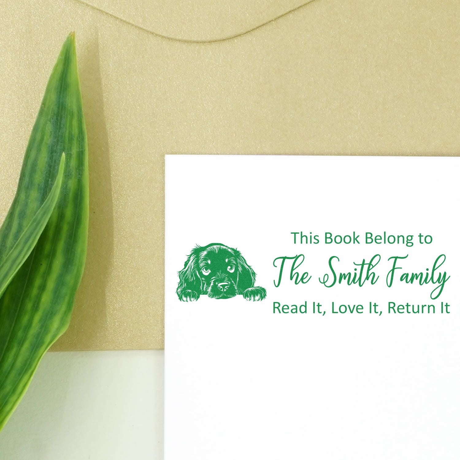 Custom book rubber stamp with dog design and This Book Belongs to The Smith Family return notice.