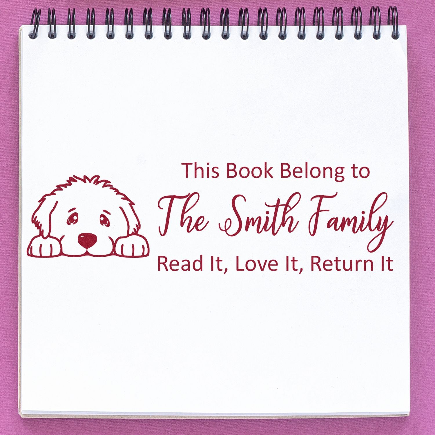 Personalized rubber book stamp with dog icon and return message for family books: This Book Belong to The Smith Family.