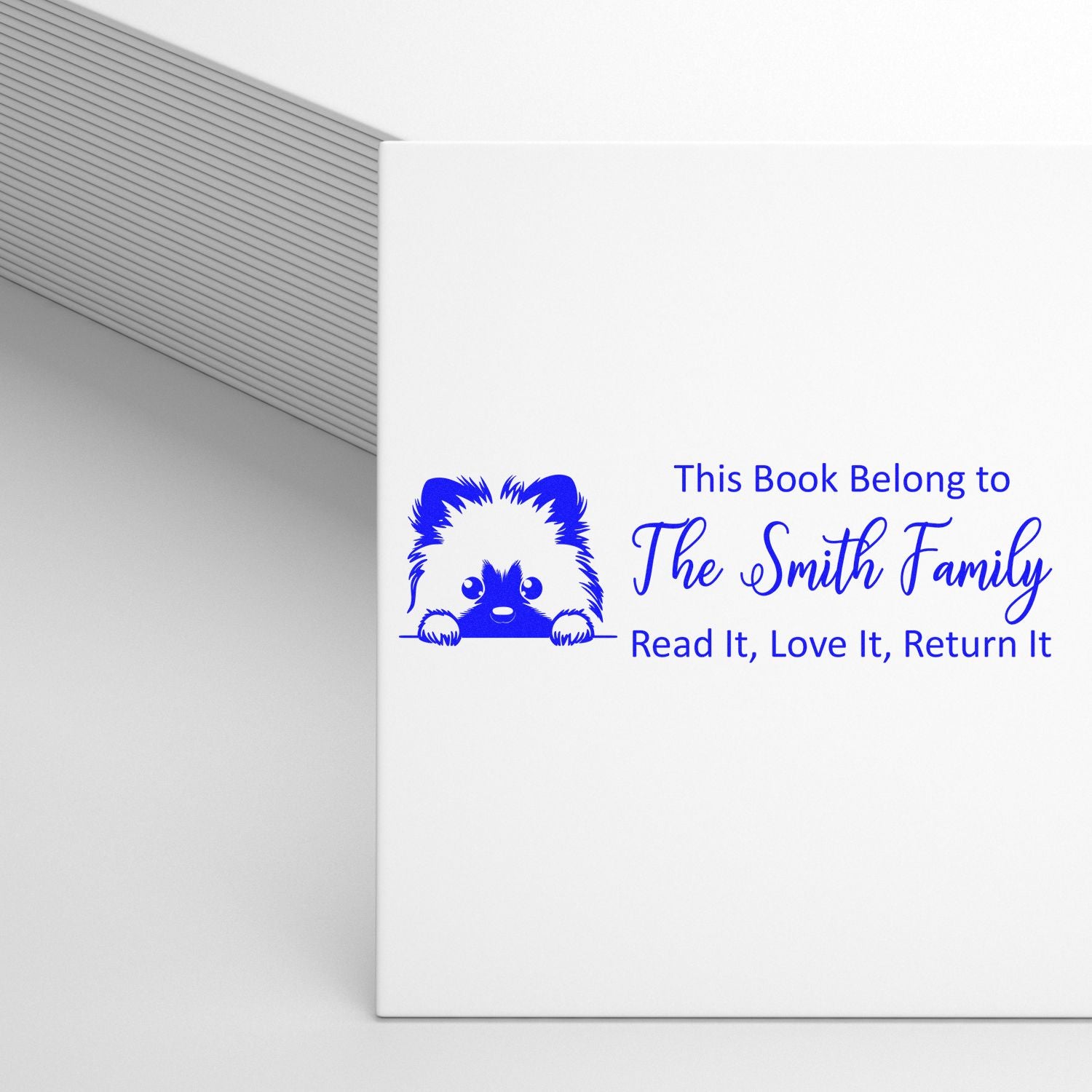 Custom rubber book stamp with dog icon reading This Book Belongs to The Smith FamilyRead It, Love It, Return It.