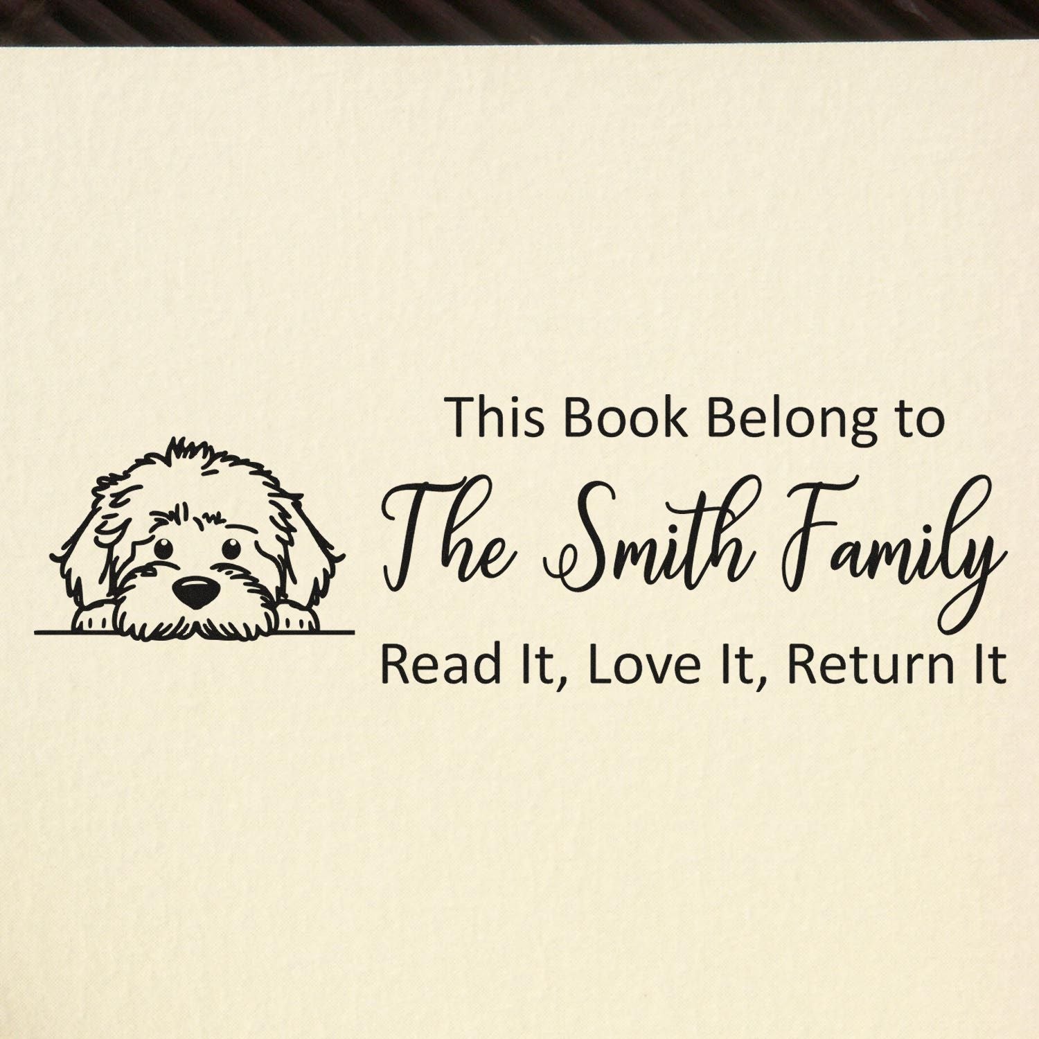 Personalized rubber stamp for The Smith Family book label with dog art and This Book Belongs To return message.
