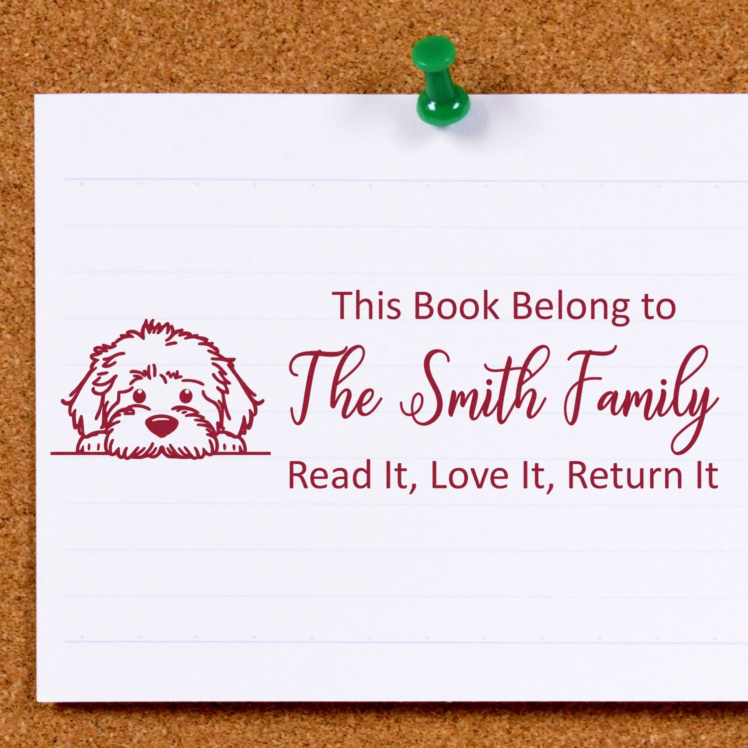 Custom book rubber stamp with dog illustration and family name, reading This Book Belongs To for personal library labels.