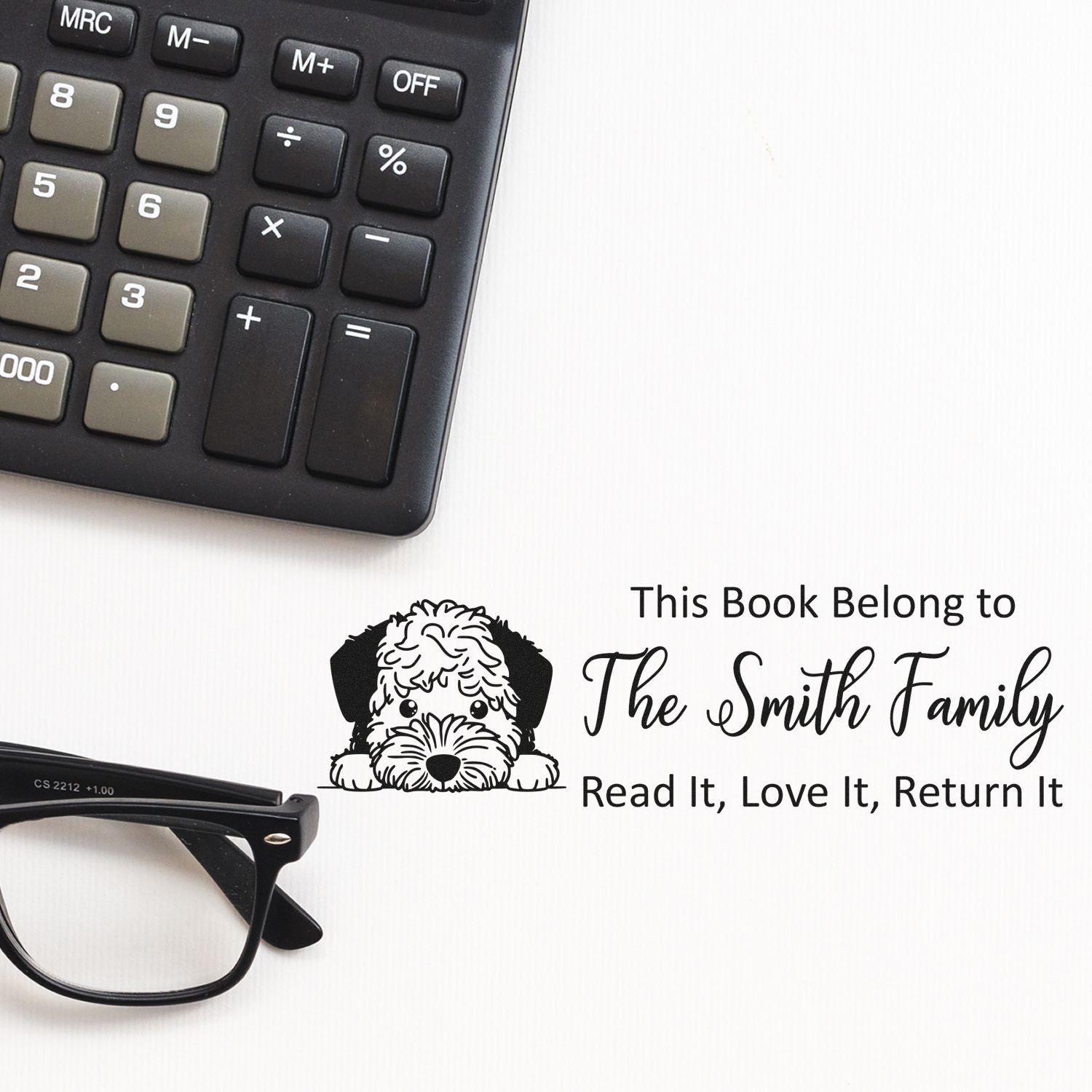 Custom book rubber stamp with dog design and personalized This Book Belongs to The Smith Family return message.