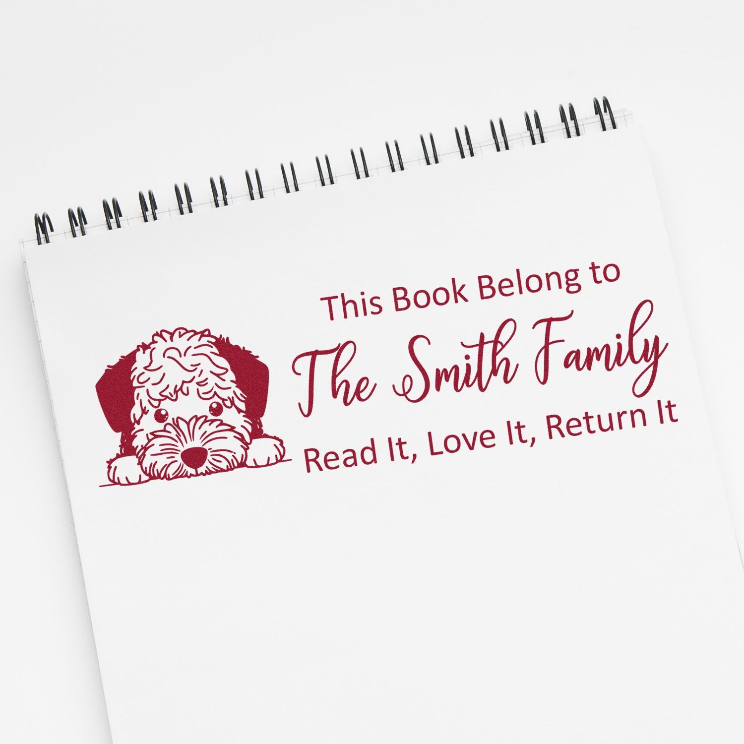 Custom book stamp with dog design reading This Book Belong to The Smith Family for personalized library bookplates.