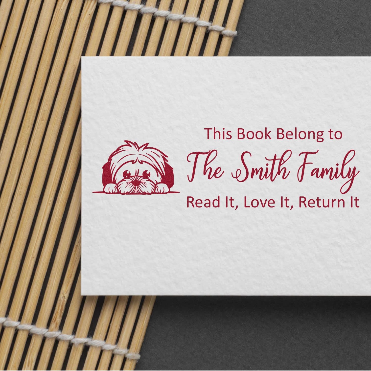 Custom book rubber stamp with dog art and This Book Belong to The Smith Family text.