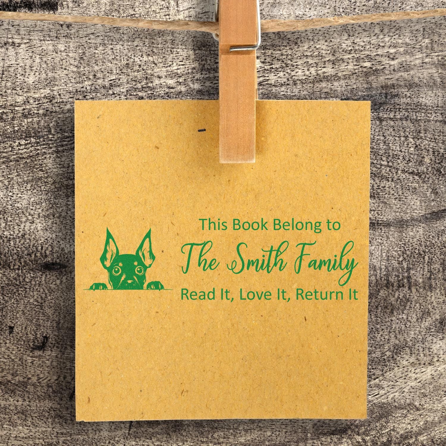 Personalized family library rubber stamp with dog icon and Read It, Love It, Return It bookplate design for books.