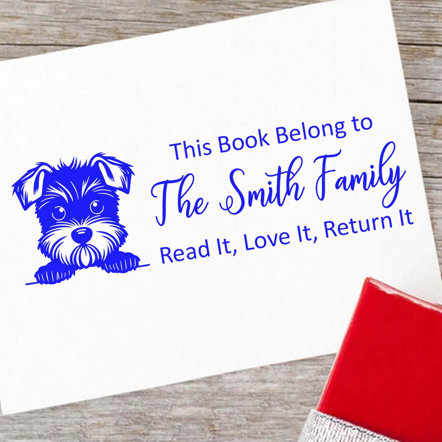 Personalized book return rubber stamp with dog design, reading This Book Belongs to The Smith Family for library books.